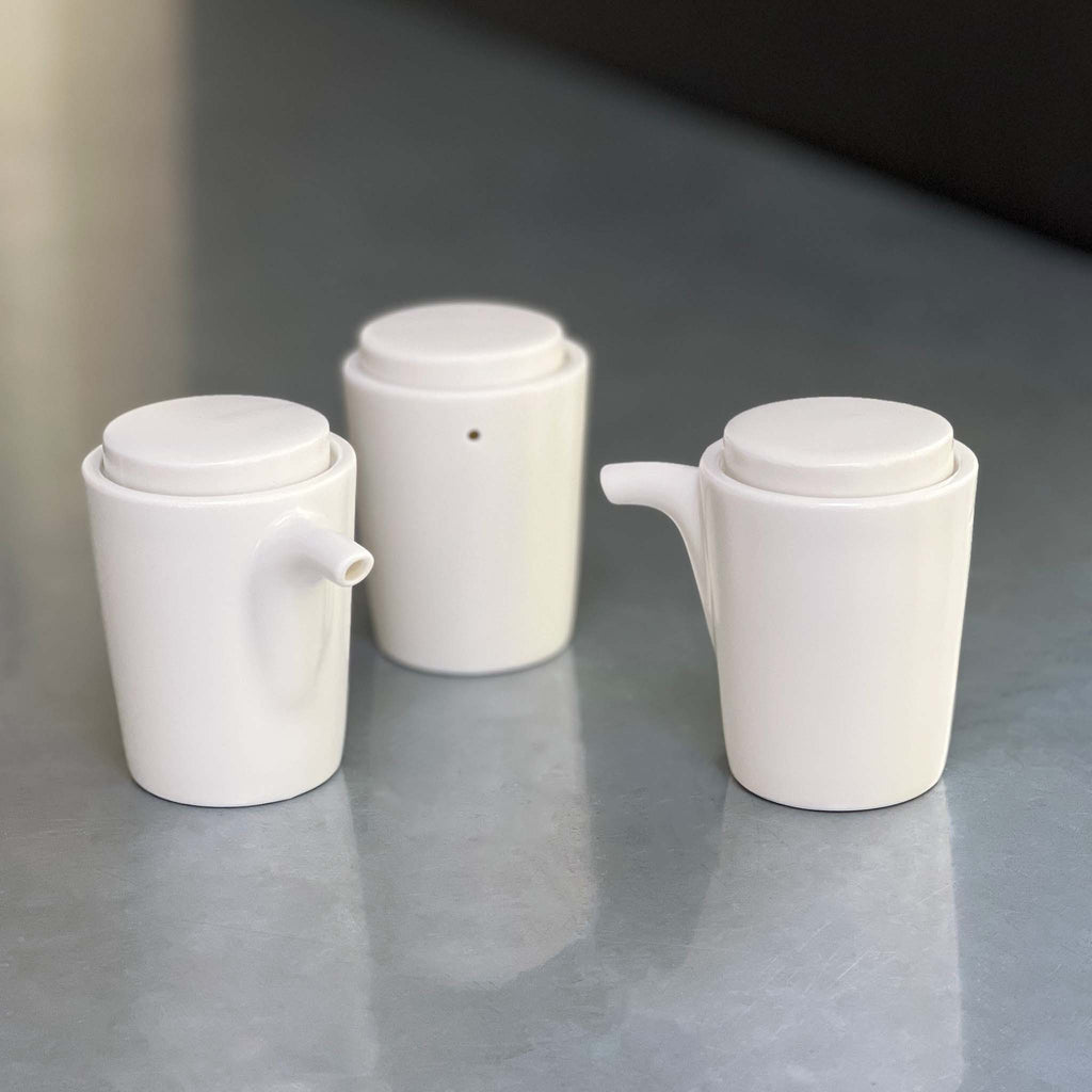 Simple cylindrical design with circular lid.  White, simple lines match any table setting