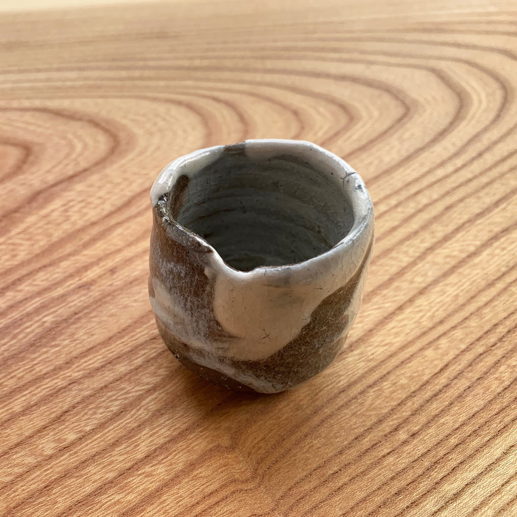 Anagama Japanese sake cup handmade dark brown with partial white glaze
