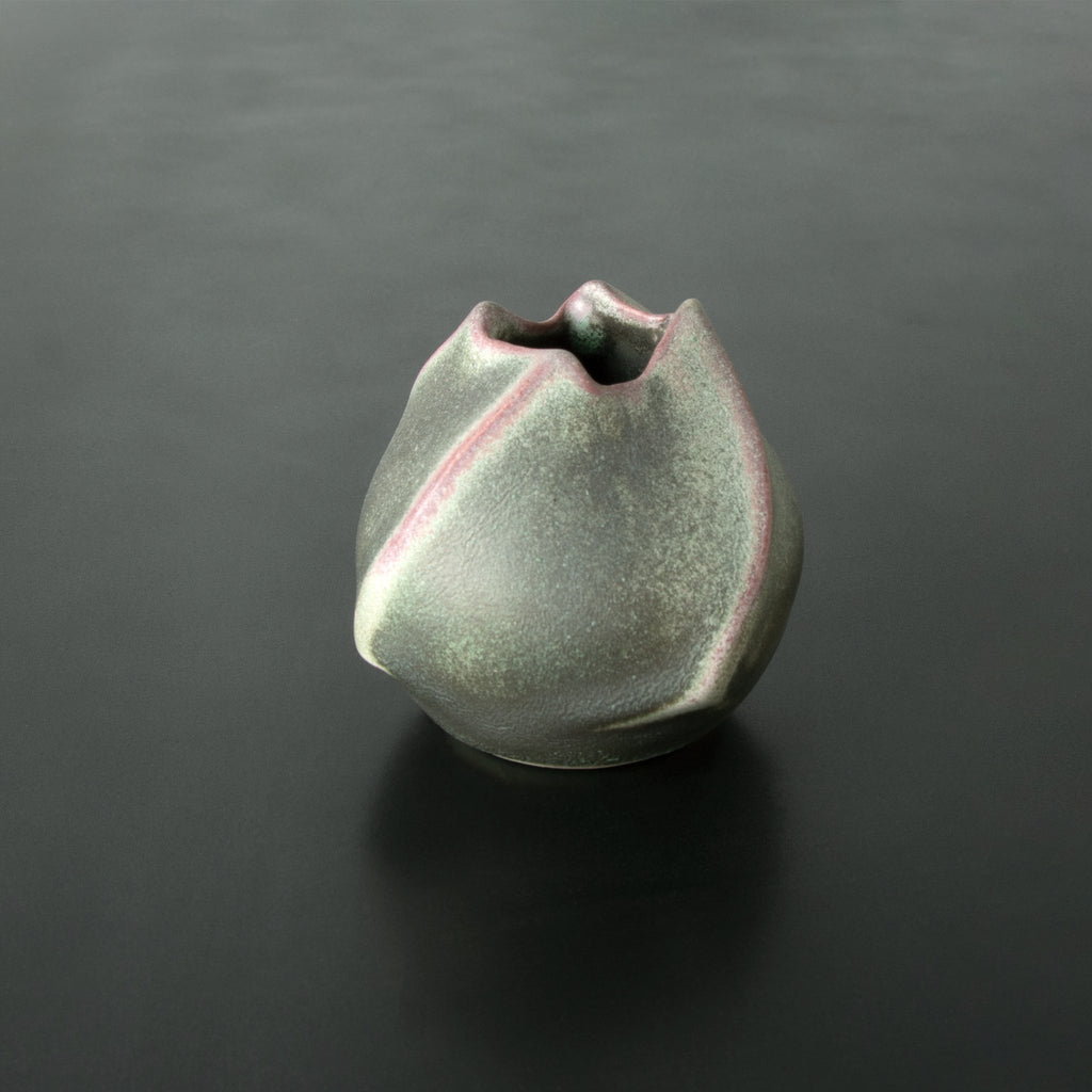 Anagama Kinyo 1 Japanese Vase, kinyo glaze and kiln ash pink spiral contours slightly textured grey background