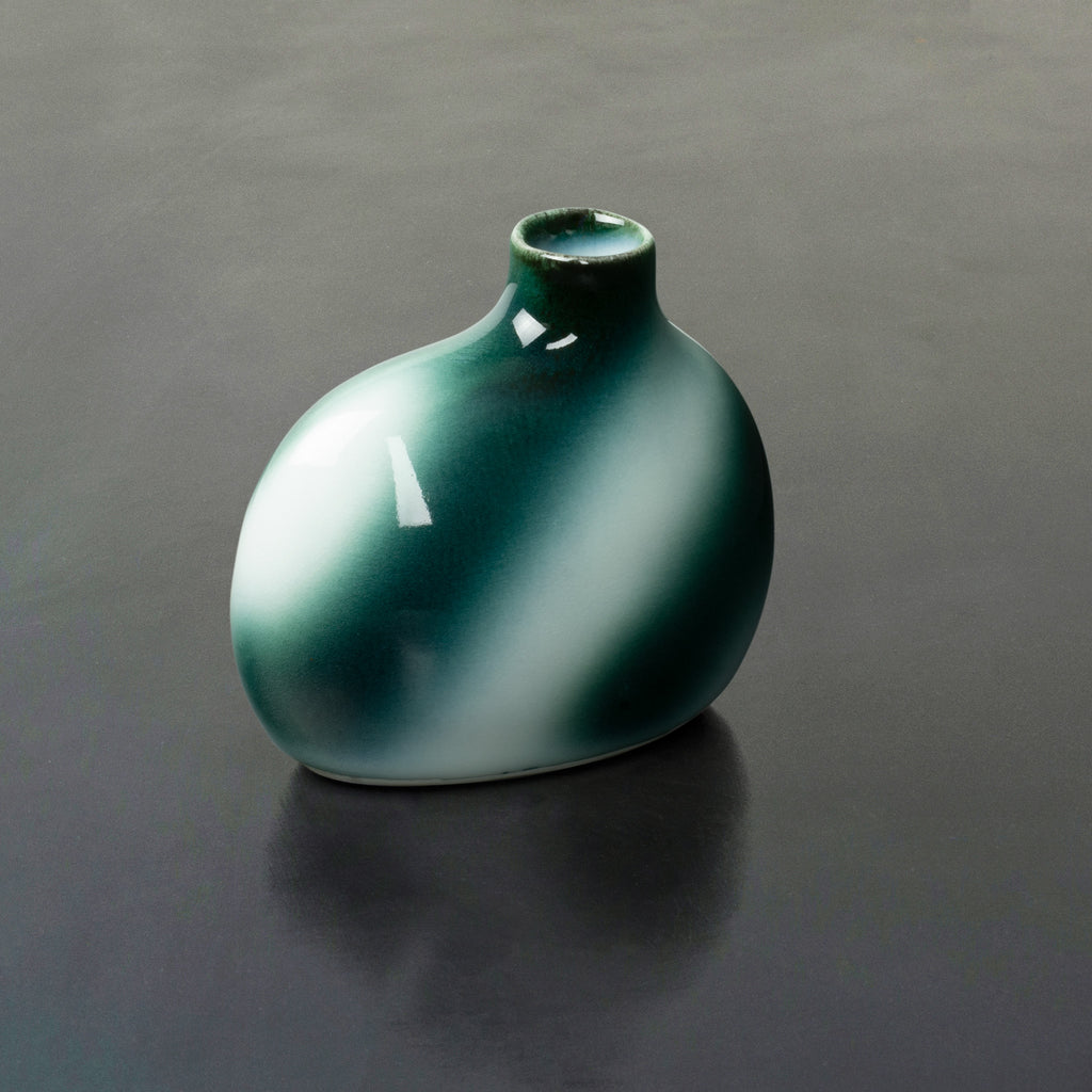Deep blue-green striped glaze design on a glossy white backdrop single stem bud vase