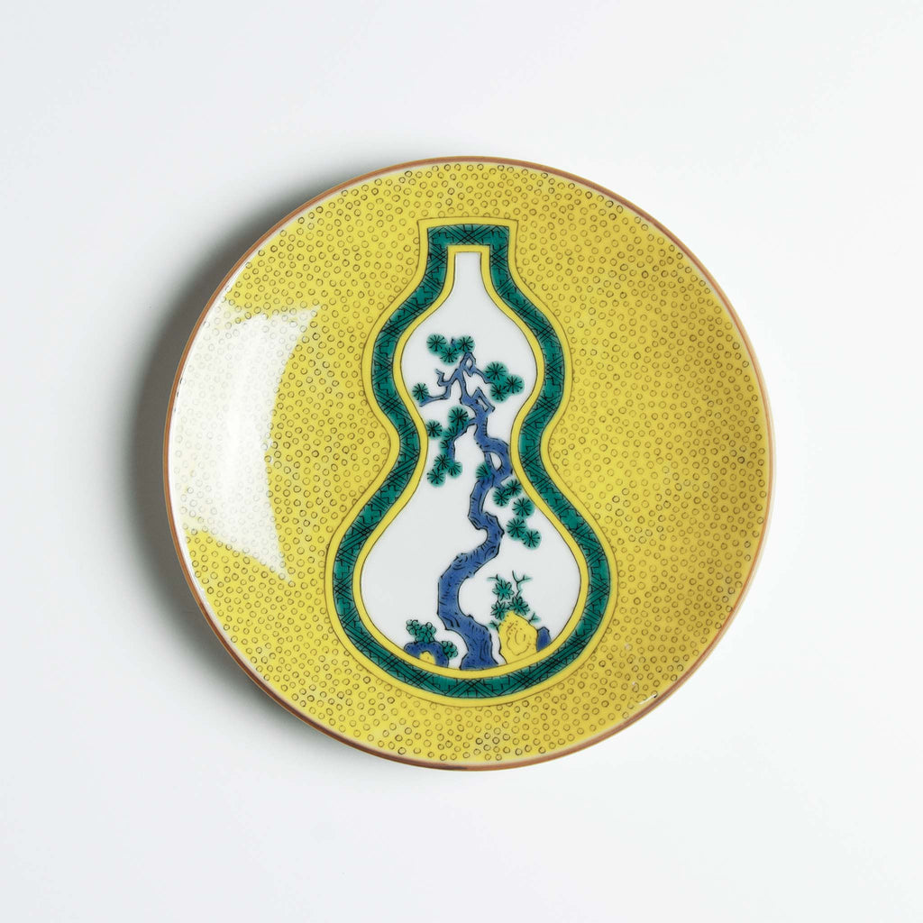 Yellow patterned dish with a pine showing through green bordered gourd shaped window